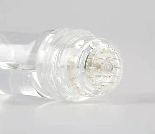 Close-up of a clear glass bottle with a white cap on a light gray background