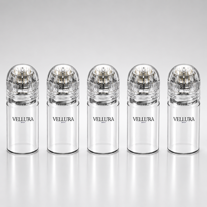 Five Vellura bottles with clear caps on a white background