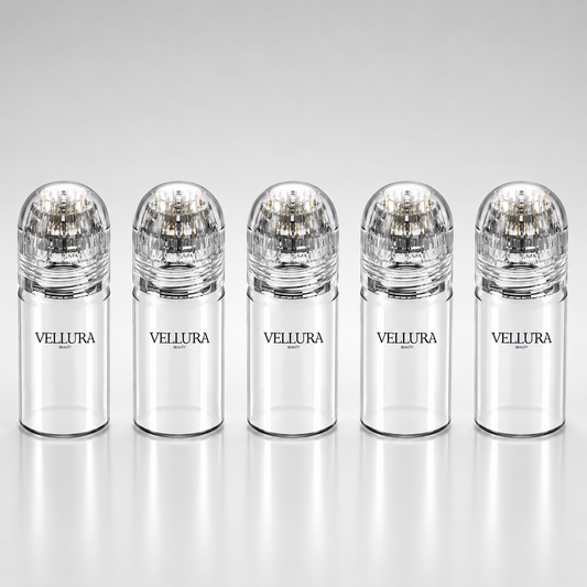 Five Vellura bottles with clear caps on a white background