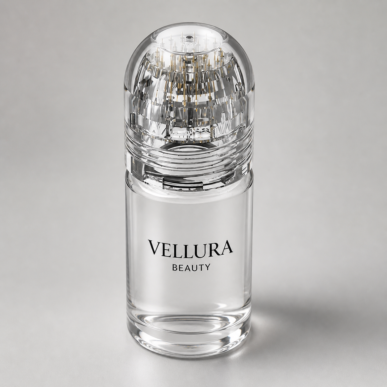 Clear Vellura Beauty bottle with decorative cap on a gray background