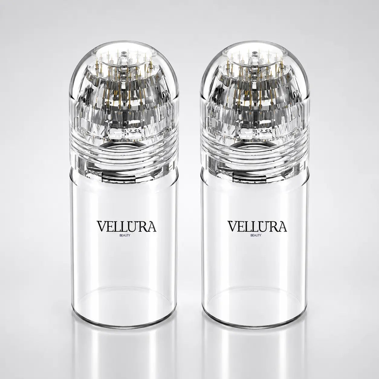 Two clear Vellura beauty products on a light gray background